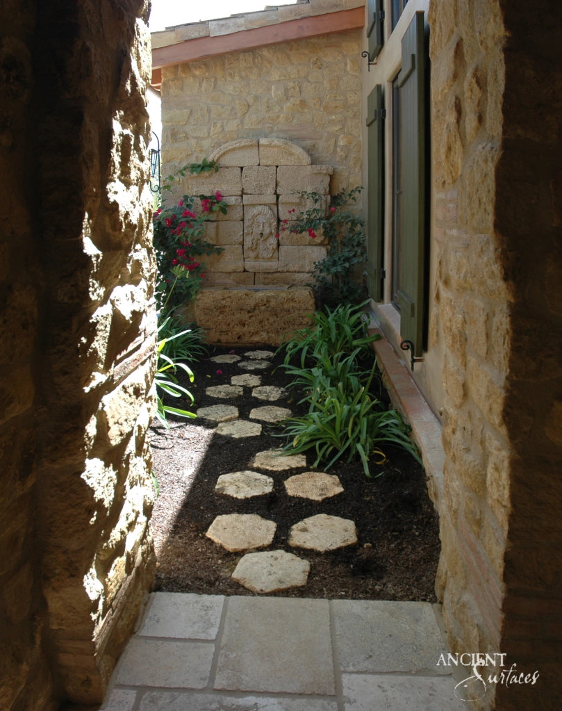 serene-courtyard-setting-with-a-majestic-limestone-wall-fountain-as-its-centerpiece-surrounded-by-nature-epitomizing-tranquility-and-design-convergence