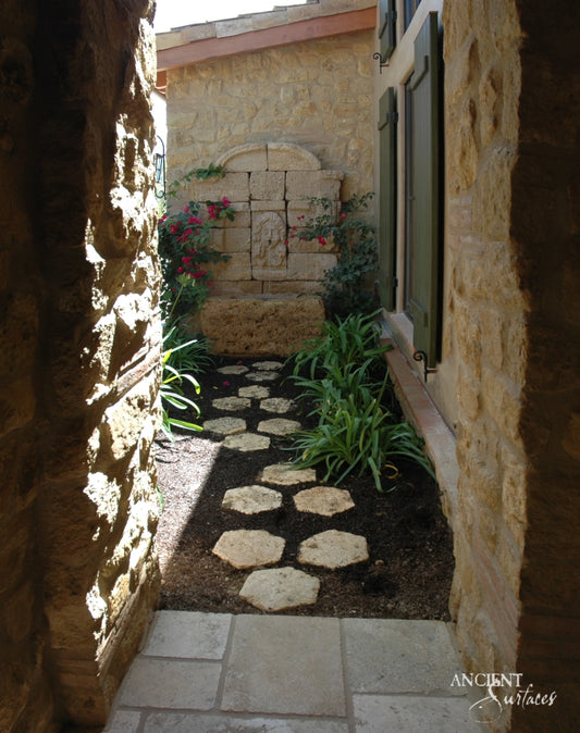 serene-courtyard-setting-with-a-majestic-limestone-wall-fountain-as-its-centerpiece-surrounded-by-nature-epitomizing-tranquility-and-design-convergence